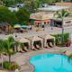 Aerial/overview image showing the campground's swimming pool area, cabanas and the plaza/office buildings — provides a broad layout view and is from the campground page imagery.