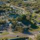 Clear aerial/drone overview showing campground layout, lake, RV sites, roads and entrance along Alt 19 — matches the About page overhead shot and is highly useful as an overall property image.
