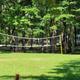 Volleyball court on a grassy area with RVs visible in the tree line — shows on‑site recreation and surrounding campsites. Image hosted on the site’s campground photo gallery.