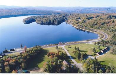 Aerial view of lakeshore with winding road