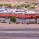 Aerial view focused on the full property facade with visible RV pads behind the building — useful to show RV resort layout (labeled on site as RV_resort header).