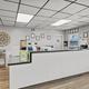 Front desk/office interior photograph showing reception counter and paperwork area — useful facility image from the property gallery.