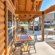 Covered porch and outdoor seating area at the clubhouse with park infrastructure visible beyond — useful to show on-site amenities and guest gathering spaces (homepage photo).