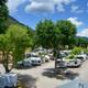 Elevated view of RV sites and internal roadways with trees and mountains in background — clear depiction of RV pitches and site spacing (from the rates/amenities pages).
