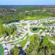 High-resolution aerial view showing the full resort layout with RV pads, roads, ponds and surrounding vegetation — good overall property overview; appears on the resort homepage background.
