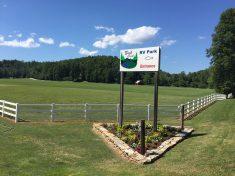 Park entrance sign and fenced field — shows property entry and landscape; comes from the campground gallery page.