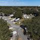Wide drone perspective of campsites and surrounding tree canopy — another clear overview from the property's gallery page.
