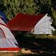 Two tents in a camp site.