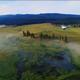 Aerial meadow view across the ranch with wetlands, distant buildings and a hot-air balloon — good overall property overview and landscape context from the resort homepage.