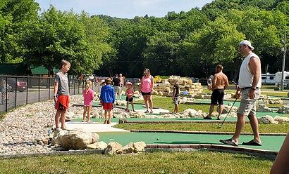 Mini-golf area with people playing — demonstrates on-site recreational amenity and layout (displayed on the Amenities page).