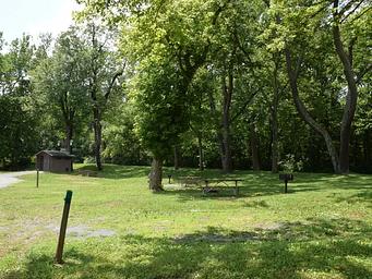 Single campsite with fire ring, picnic table and grill.  