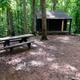 Cabin A5, a four-person cabin with a picnic table and grill.
