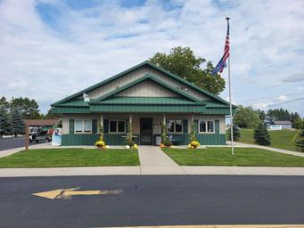 Exterior view of the park store/office building with flagpole and paved entrance — documents on-site facilities and arrival area (source page: homepage).