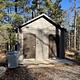 A photo of a vault toilet and trash facility at Island lake (MI)
