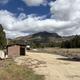 Scenic view of campground with vault toilets and trash bin