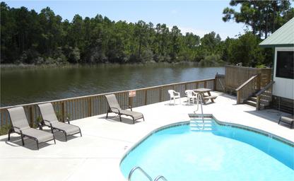 Pool and clubhouse deck overlooking the water — shows guest amenities and scenic view from central facilities (Clubhouse View Overlooking Water).