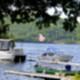 Shows boats moored on a lake with tree-lined shore — supports waterfront/boat-launch amenity; image is from the Amenities page on the campground site.