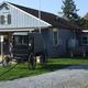 Wide exterior shot of the campground office/entrance area with an antique buggy on the lawn — useful overview of the park facilities and entrance; comes from the site’s Our Park feature image.