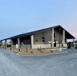 Exterior photograph of the main clubhouse/building with drive approach and parking — useful to show facilities and arrival area (from the resort website gallery).