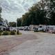 View down a gravel lane lined with RVs and trailers — useful depiction of the campsite/RV pitch area on the property (from the site’s image set).