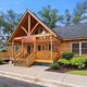 Exterior of the log-style clubhouse/office building on the campground grounds — clear view of the building style and entrance, helpful to show on-site facilities; matches homepage gallery context.