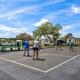 Outdoor courts with people playing (pickleball/tennis) and RVs visible in the distance — shows active recreational area from the campground photo gallery.