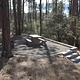 White Spar Campsite with table and fire ring on raised rock walled platform