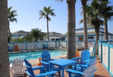 Clear, high-resolution photo of the pool area and surrounding deck/chairs with resort buildings visible — good image of on-site amenities (from the site's amenities images).