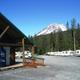 Shot of the office/building entry with vending machine, adjacent RV spaces and mountain backdrop — shows guest facilities and typical RV parking area (from the Park Rules page).