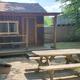 Small cabin with picnic table, fire ring and yard area — clear campsite/cabin setting for guests (source: Rental Rates & Info page).