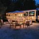 Decorated campsite at Sleepy Hollow campground with RV, firepit, lights, and chairs.