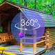 Panoramic/360-style banner image featuring a cabin, picnic table and wooded surroundings — good aerial-style horizontal view highlighting site cabin and setting. 