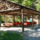 Open-sided pavilion adjacent to the pool with seating — shows outdoor amenity/picnic shelter on the campground grounds (Pool page).