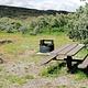 A campsite at South Rim Campground showing the firepit and picnic table.