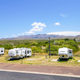 Wide panoramic view of an RV row on-site showing multiple parked RVs and the surrounding landscape — good aerial/overview of the resort's RV lot. Image appears on the property homepage and 'RV SITES AND BOAT STORAGE' content.