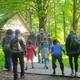 Pathway/grounds view with visitors walking toward a wooded building — useful overall campground exterior shot demonstrating trails/grounds and visitor access (from Birthdays/gallery context).