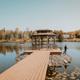 Clear scenic shot of the property’s dock/gazebo on a lake with surrounding trees — shows on-site waterfront amenity and appears on the resort gallery page.