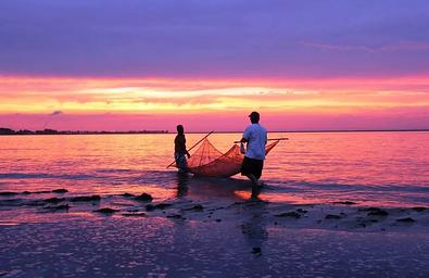 Two park visitors seining while the sun is setting