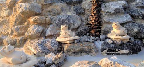 Detail shot of decorative stonework and frog sculptures likely part of the park's landscaping/waterfall feature; complements clubhouse and grounds photos shown on the site.