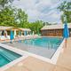 Wide, high-quality view of the resort swimming pool and surrounding deck/amenity buildings — matches the About page pool photo and shows a primary on-site facility.