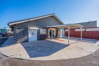 Another wide-angle exterior of the office/entry area from a slightly different perspective, including ice machine and parking — provides additional context for facilities and layout (gallery).