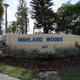 Park entrance sign reading 'Highland Woods' with landscaping — confirms property identity and shows the resort entry area (from the property page).