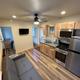 Interior kitchen/living area of a cabin showing kitchenette, seating and layout — demonstrates cabin interior amenities from the Cabins & Trailers gallery.