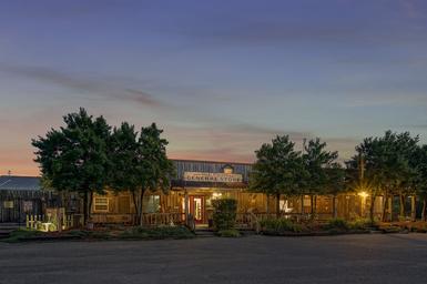 Evening exterior of the park’s general store/office building — shows facilities and character of the property (gallery page).