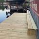 A wooden dock with a sign that says marina on it