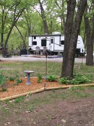 Large seasonal RV site with trailer and landscaped area — demonstrates a typical RV/seasonal pitch and site layout on the property.