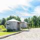 Pair of round/yurt-style cabins near gravel roadway and picnic area — shows alternative cabin types and site layout (Old Goat/other cabins page background).
