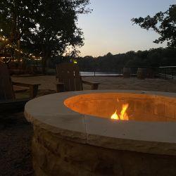 Evening firepit by the lake with seating and lights — shows common outdoor amenity and matches the site's firepit/lake imagery.