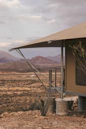 Canvas luxury safari tent with views of the Christmas Mountains at Camp Elena in Terlingua, Texas, near Big Bend National Park.