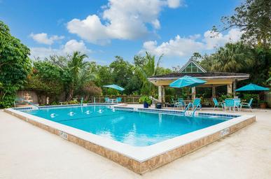 Clear daytime photograph of the main outdoor swimming pool, pool deck and lounge furniture — matches the site’s pool/gallery content and labeled as the community pool.